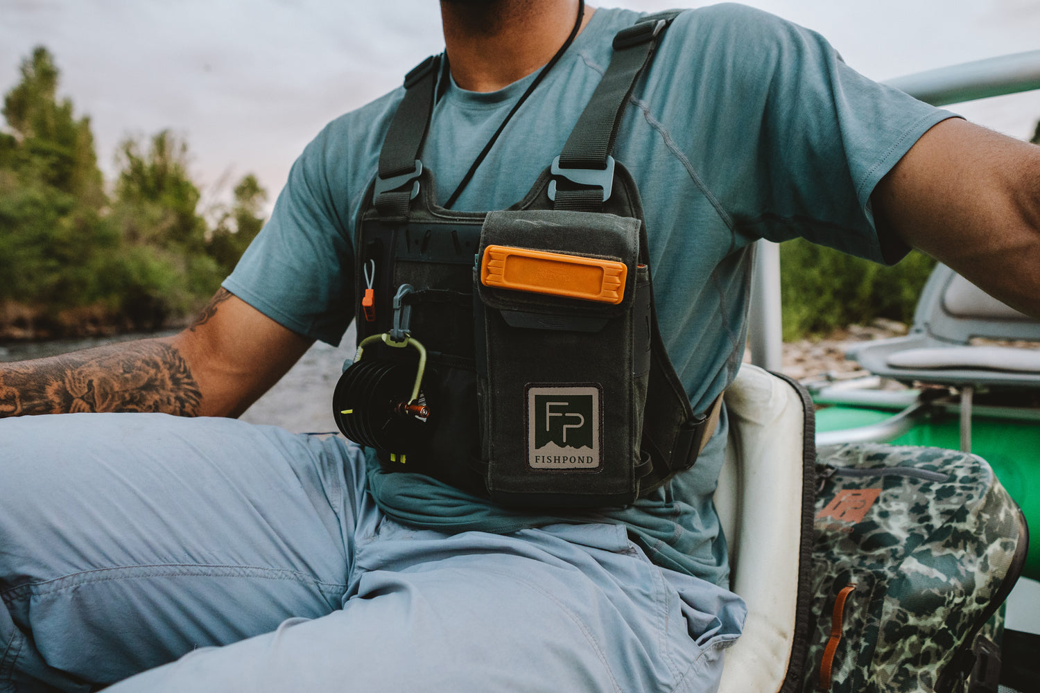 The Fishpond Stormshadow's slim waxed-cotton front — waterproof pocket, magnetic fly-box compartment, and fly patch